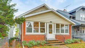 A two-story house with a front porch, a brick exterior, and a covered entryway. - 3 Mi to Dtwn: Unique Toledo Retreat (Toledo)