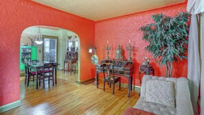A dining area with a wooden table and chairs, a mirror, and a green cabinet. - 3 Mi to Dtwn: Unique Toledo Retreat (Toledo)