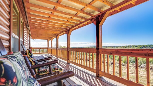 A covered porch with wooden railings and benches, overlooking a scenic landscape. - 17 Mi to Tarleton State: Mtn-view Hideaway! (Stephenville)