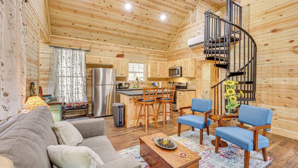 A cozy cabin interior with a kitchen, dining area, and living room. - Near Greenbrier River! Mtn-view Cabin w/ Fire Pit (Marlinton)