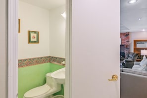 Enter a stylish room with a modern design, featuring a white toilet and a patterned border above.