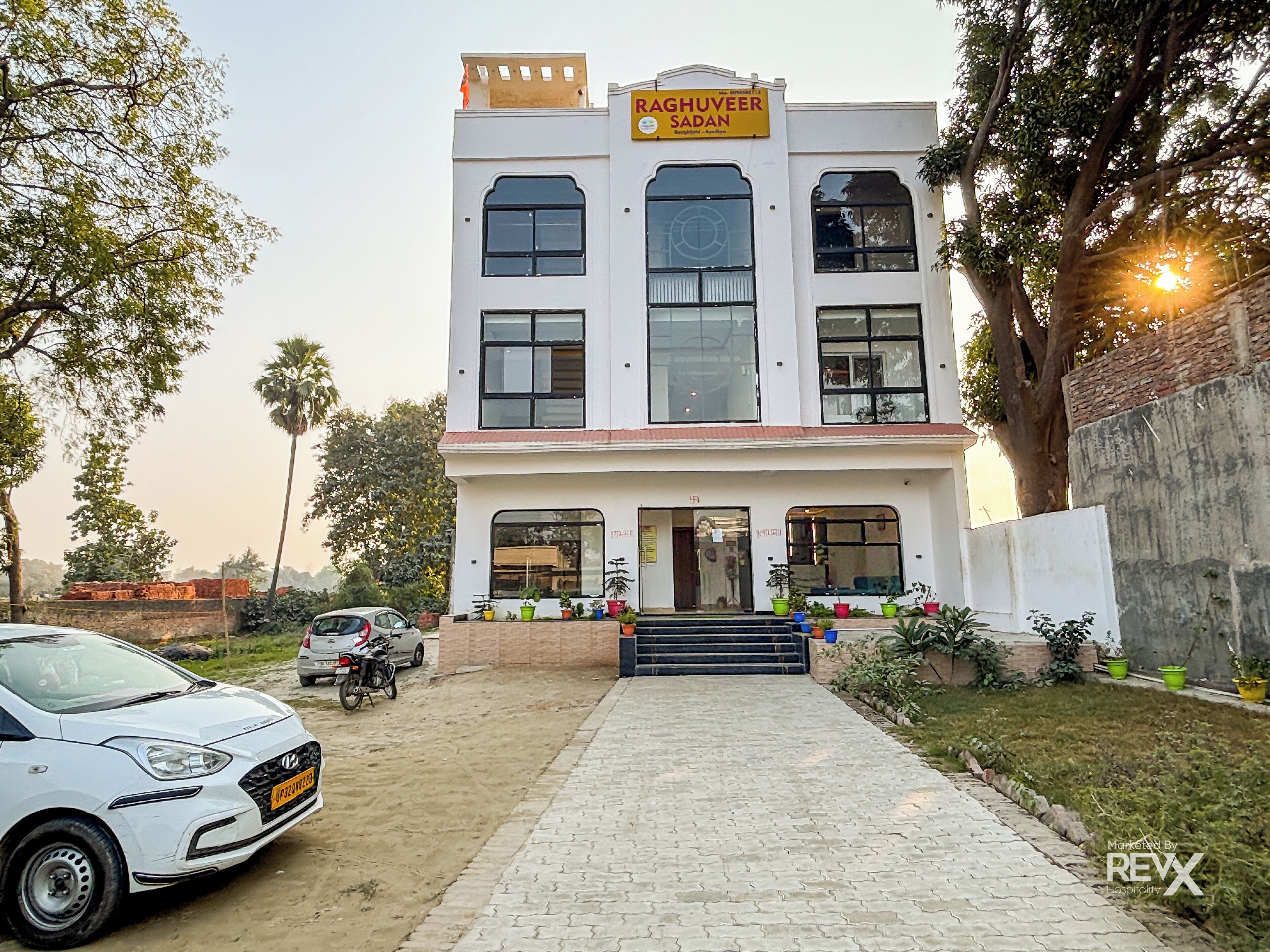 A two-story building with a sign reading "Raghueer Sadan."