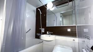 Une salle de bain moderne avec une douche à parois de verre, un lavabo blanc et des toilettes.