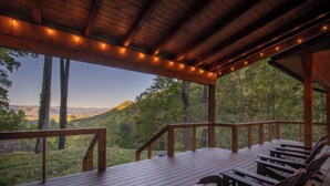 A wooden deck with benches overlooking a forested landscape. - Mountain Creek View-Hot Tub - Views - Gas Firepit (Whittier)