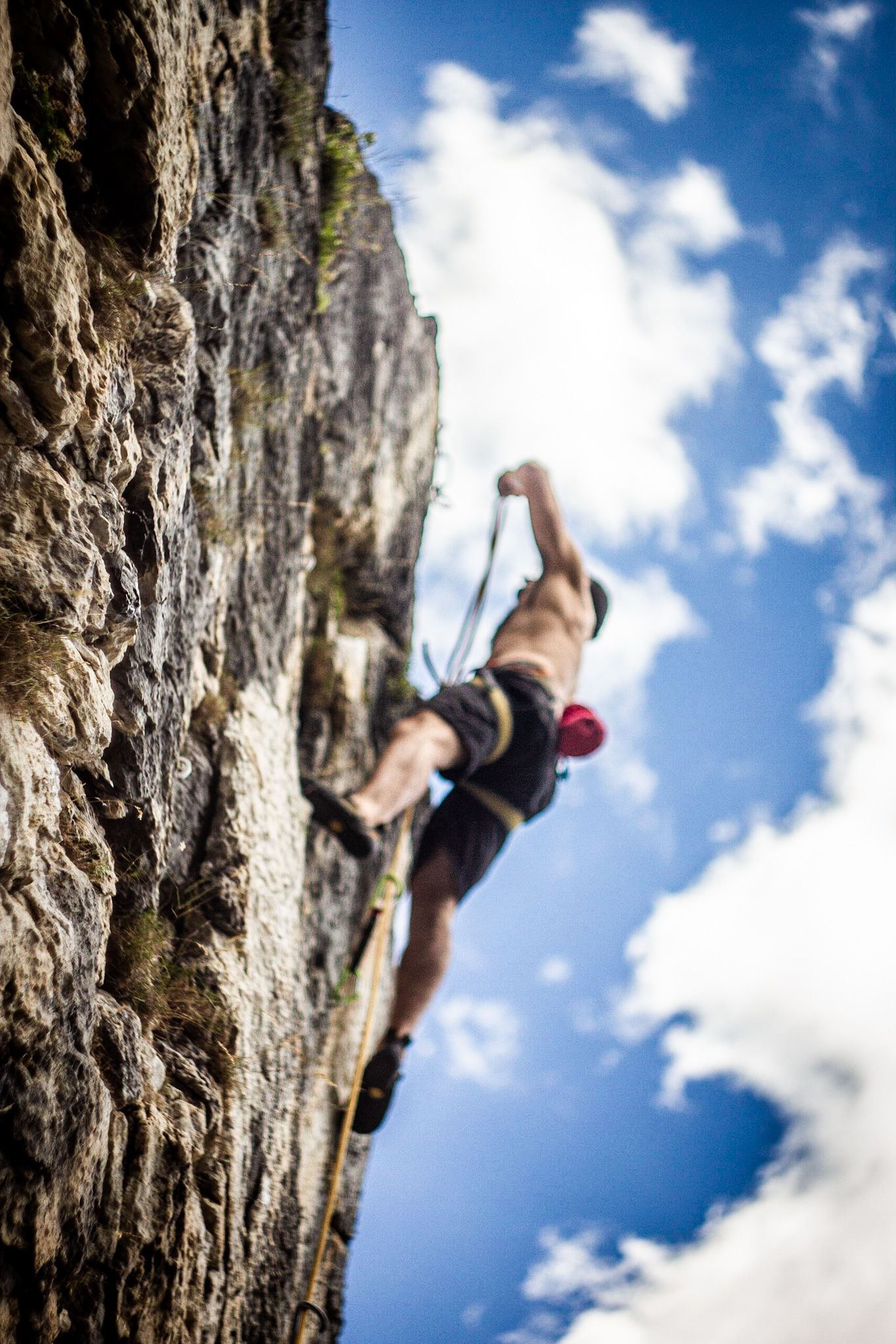 A person climbing a rocky cliff.