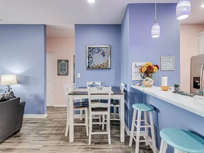 Enjoy meals in the kitchen with a dining area, bar, and refrigerator.