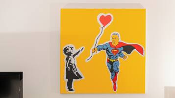 A painting of a superhero holding a heart-shaped balloon, with a child reaching out.