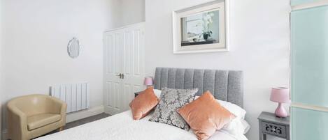 Desk, iron/ironing board, bed sheets