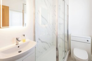 Shower, hair dryer, towels, shampoo