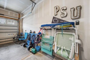 A garage with a medical tent, a Penn State logo, and a wheelchair.
