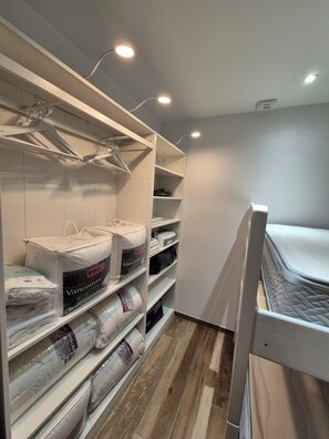 A storage closet with shelves holding various items like bags and pillows. - Apartment Tignes (Tignes)