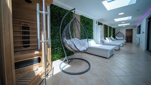 A modern interior with a hanging chair, a sofa, and a staircase. - 22-guest luxury stay with Pool & Bar (Lytham St Annes)