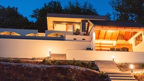 A modern two-story house with a covered outdoor area and a staircase leading to the entrance. - Luxury Villa with big private swimming pool surrounded by forest and wineyards (Imotski)