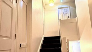 A staircase with dark steps leading to a landing with a door marked '2'. - Spacious Sheffield Lodge (Sheffield)