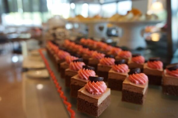 A buffet with various desserts, including cupcakes and pastries.