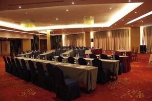 A conference room with multiple tables, chairs, and a stage. - Sabah Oriental Hotel Kota Kinabalu (Kota Kinabalu)