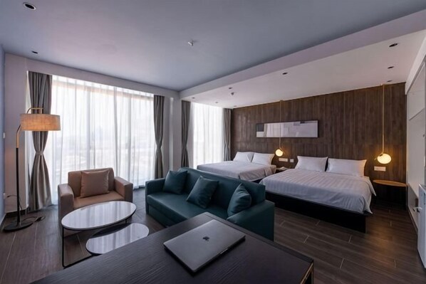 A modern hotel room with a bed, sofa, and desk. - Grace Samudera Hotel (Semporna)
