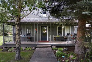 A house with a porch, a front door, and a small garden area.