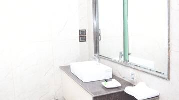 Combined shower/bathtub, hair dryer, slippers, towels