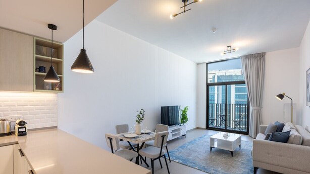 A modern apartment with a kitchen, dining area, living room, and balcony. - Belgravia Heights 1 - Tranquil One Bedroom in JVC (Jumeirah Village Circle)