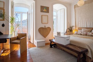 Relax in a beautifully furnished bedroom with a large bed, bedside table, and comfortable seating area.