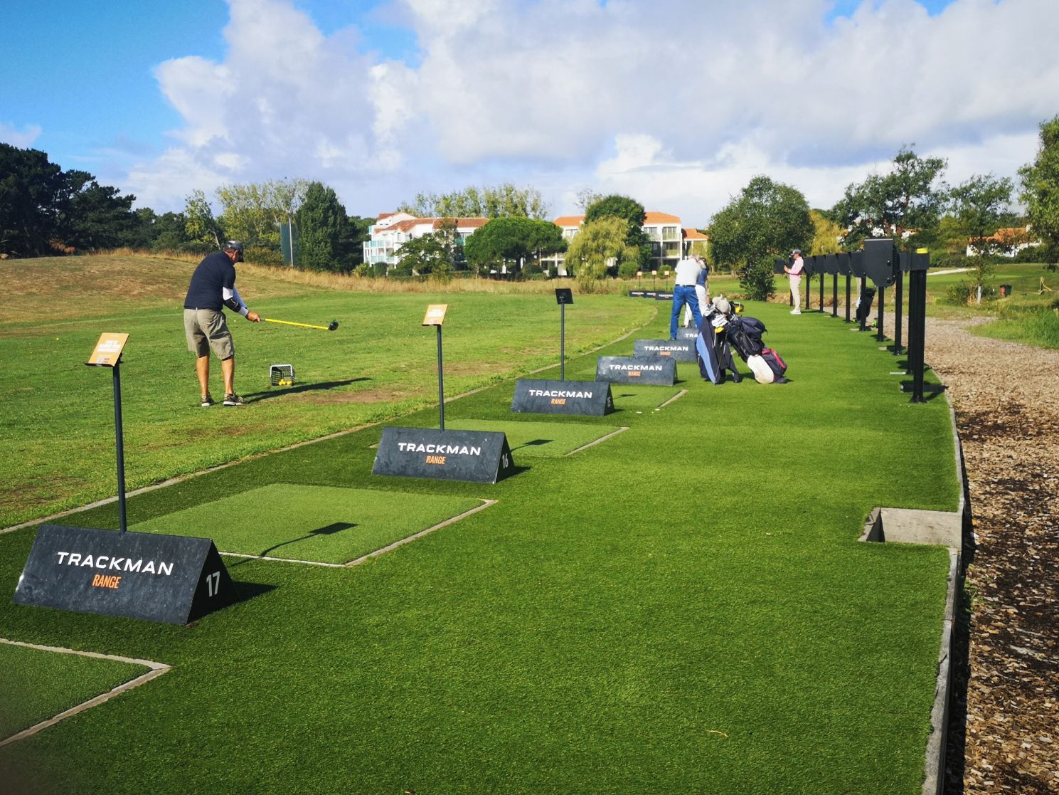 A golf driving range with multiple tees marked as 'TRACKMAN RANGE'.