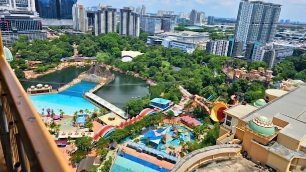A resort with a pool, water slides, and a view of a cityscape. - Sunway Studio Homestay 1-min walk Sunway Pyramid Mall & Lagoon by Cloud Host (Subang Jaya)