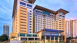 A modern university building with multiple floors and a prominent entrance. - Sunway Studio Homestay 1-min walk Sunway Pyramid Mall & Lagoon by Cloud Host (Subang Jaya)