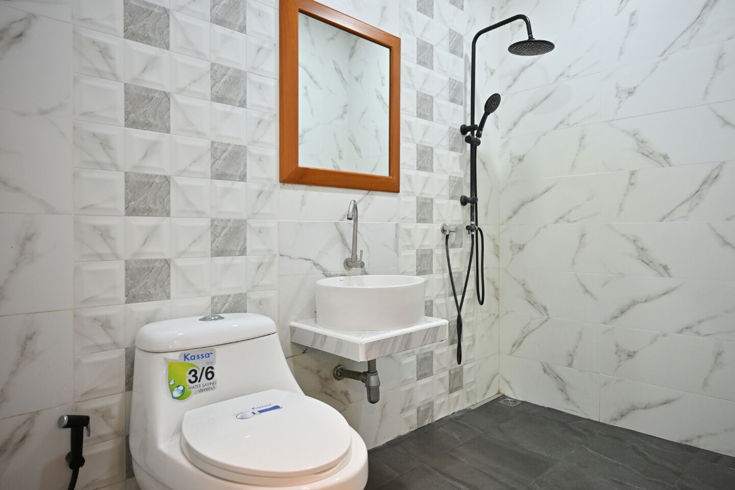 A bathroom with a toilet, sink, and shower.