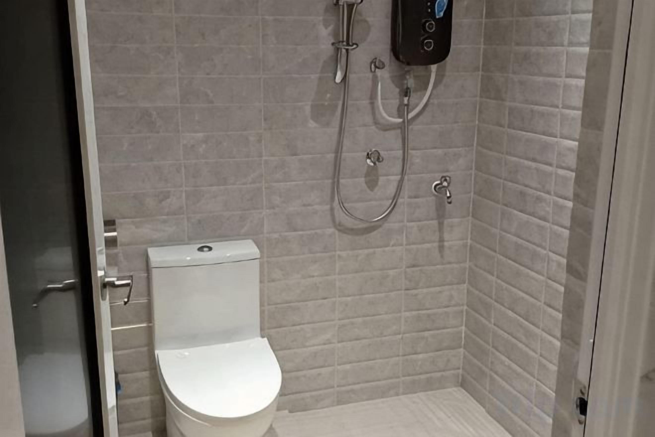 A bathroom with a toilet, a shower, and a wall-mounted control panel.