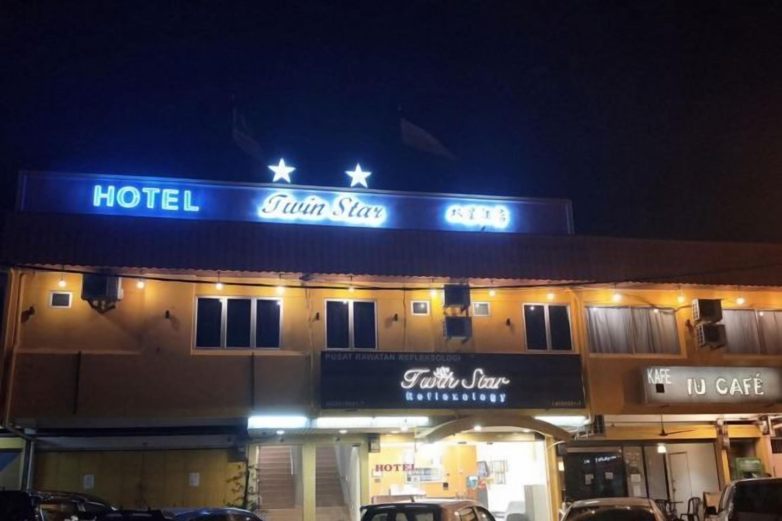 A hotel named Twin Star with a sign indicating a coffee shop and a medical office.