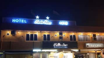 A hotel named Twin Star with a sign indicating a coffee shop and a medical office.