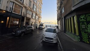 A narrow street with parked cars and buildings on either side. - Seaside Hotel  (Brighton)