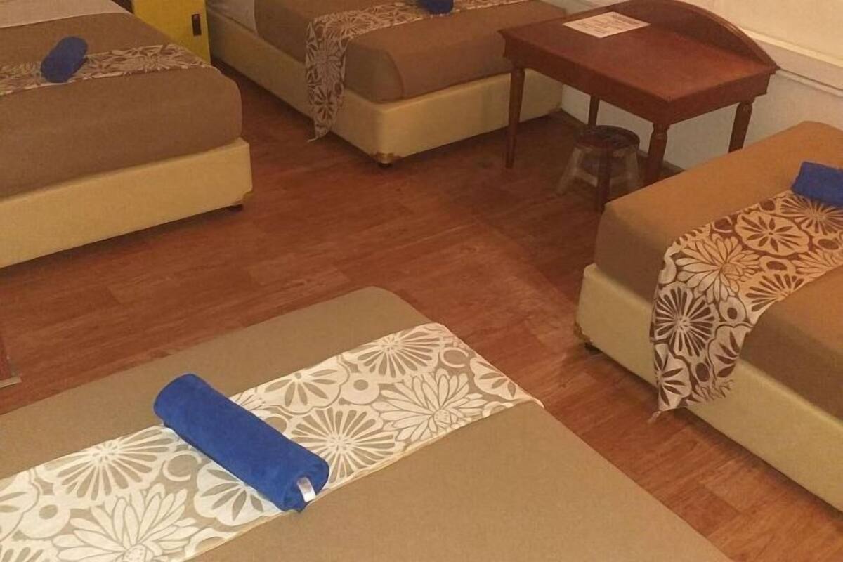 A room with two sofas, a small table, and a patterned rug.