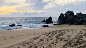 A beach with large rocks and footprints in the sand. - 3BDOceanview Villa at MontecristoEstates (Cabo San Lucas)
