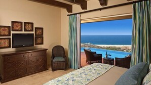 A bedroom with a large bed, a television, a dresser, and a view of the ocean. - 3BDOceanview Villa at MontecristoEstates (Cabo San Lucas)