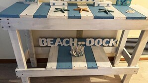 A wooden table with a beach-themed design, featuring starfish and a mermaid painting. - Lemon Bayview Villa - Heated Pool - Tennis - Dock (Englewood)