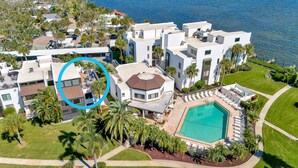 A modern residential complex with a swimming pool, multiple balconies, and lush landscaping. - Tamarind 3BR Loft – Beach Vibes & Bay Views (Englewood)