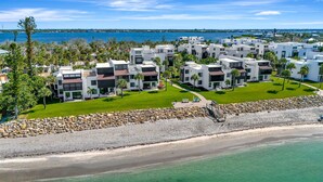 A coastal resort with modern white buildings, a sandy beach, and a view of the sea. - Tamarind 3BR Loft – Beach Vibes & Bay Views (Englewood)