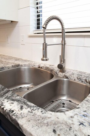 Enjoy cooking in this well-equipped kitchen with two sinks and a flexible faucet.