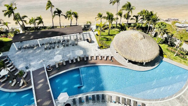 A resort with a swimming pool, lounge areas, and a beach view. - Luxury  2 Bedrooms Apartment at an exclusive tower by the beach in Zona Dorada 
 (Mazatlán)