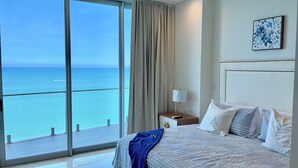A hotel room with a large window offering a view of the ocean. - Luxury  2 Bedrooms Apartment at an exclusive tower by the beach in Zona Dorada 
 (Mazatlán)