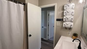 Shower, hair dryer, towels, soap