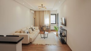 A modern living room with a sofa, coffee table, and TV.