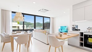 A modern hotel room with a dining area, a sofa, and a kitchen. - B201 - Wonderfull Apartment with terrasse (Sint Maarten)