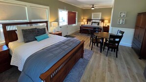 A bedroom with a bed, bedside tables, a desk, and a chair. - Bungalow #1 by Polo House and Bungalows (Santa Ynez)