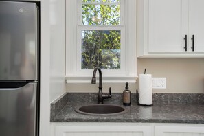 Fridge, microwave, coffee/tea maker, cookware/dishes/utensils