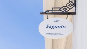 A sign for 'The Sagunto ForFriends Village' with a geometric design. - Bungalow #1 by Polo House and Bungalows (Santa Ynez)