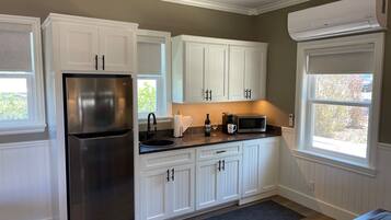 Fridge, microwave, coffee/tea maker, cookware/dishes/utensils