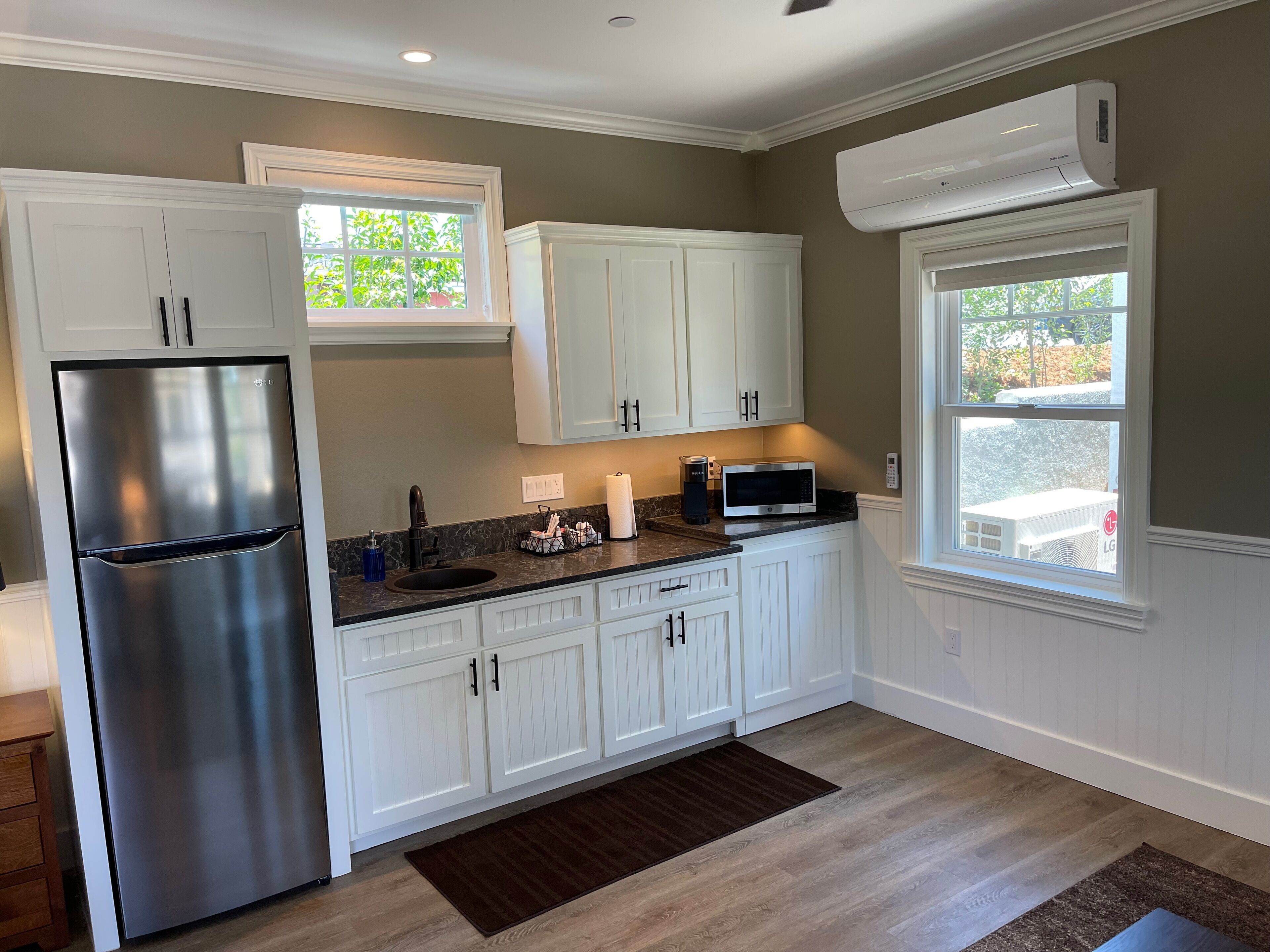 Fridge, microwave, coffee/tea maker, cookware/dishes/utensils